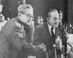 Japan Socialist Party Right Faction Chairman KAWAKAMI Jotaro (left) shaking hands with Left Faction Chairman SUZUKI Mosaburo (right), with post of new Chairman of unified Party being taken by SUZUKI. From "Mainichi Gurafu no.285"